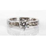 A DIAMOND RING, SCHWARTZ centred with a brilliant-cut diamond weighing approximately 0.68cts, the