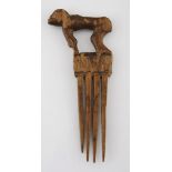 A CHOKWE COMB, ANGOLA the handle carved in the form of a baboon 20cm long