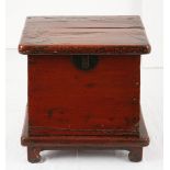 A CHINESE RED-LACQUER CHEST, 19TH CENTURY the rectangular shaped hinged lid enclosing a compartment,