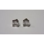 A PAIR OF DIAMOND EAR STUDS each of square form, centred with two baguette-cut diamonds, within a