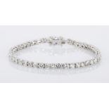 A DIAMOND TENNIS BRACELET claw-set with forty-eight brilliant-cut diamonds weighing approximately