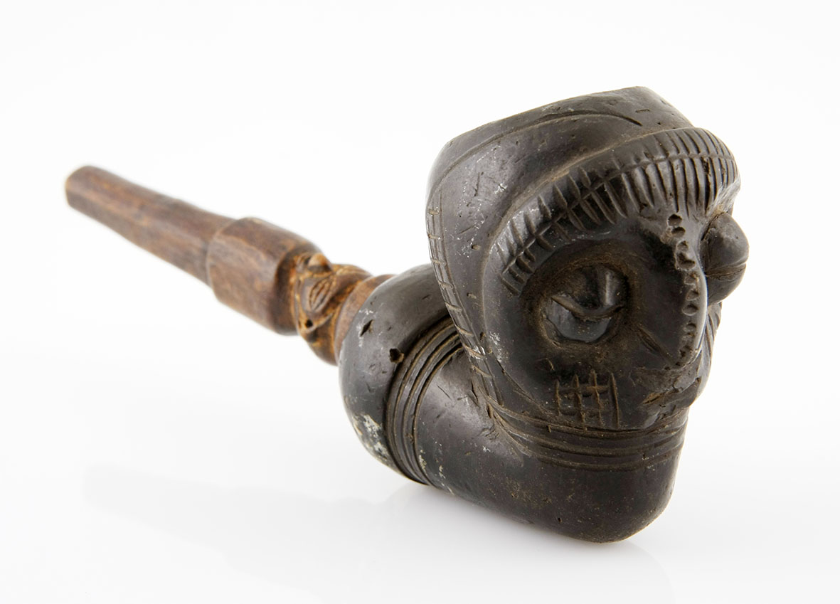 A YAKA PIPE, DEMOCRATIC REPUBLIC OF CONGO the bowl and stem carved with masks 18cm long