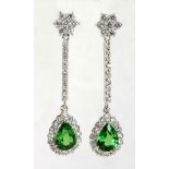 A PAIR OF TSAVORITE AND DIAMOND PENDANT EARRINGS each designed as a line of round brilliant-cut