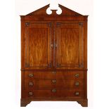 A DUTCH FLAME MAHOGANY ARMOIRE in two parts, the outswept cornice above a plain frieze surmounted by