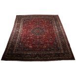 A MESHED CARPET, EAST PERSIA, MODERN the  burgundy red field with a black floral star medallion,