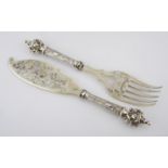 A PAIR OF SILVER FISH SERVERS, POSSIBLY FRENCH each handle decorated with scrolls, foliage and