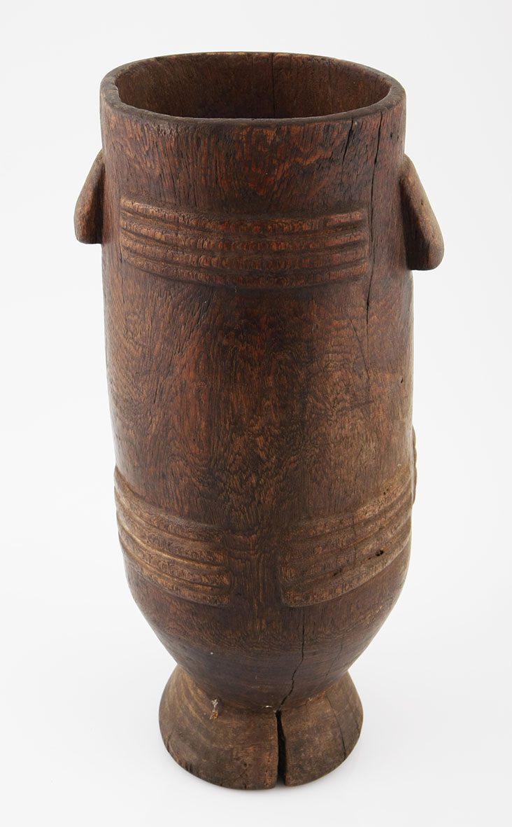 A ZULU MILK PAIL, SOUTH AFRICA of typical form, carved handles, the sides decorated with carved