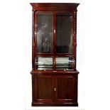 A VICTORIAN MAHOGANY PHARMACEUTICAL CABINET in two parts, the outswept cornice above a dentil