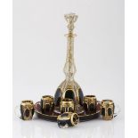 A BOHEMIAN RED STAINED AND GILT LIQUEUR SET, LATE 19TH CENTURY each cut with a band of lozenges