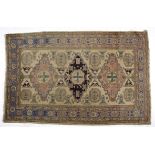 AN INDO PERIAN RUG, MODERN the ivory field with three geometric medallions in rose and dark blue