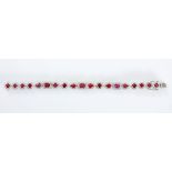 A RUBY AND DIAMOND BRACELET claw-set with circular-, pear- and emerald-cut rubies weighing