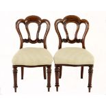 A SET OF EIGHT MAHOGANY DINING CHAIRS the shaped top rail above a pierced and moulded splat,