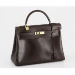 A VINTAGE HERMES KELLY HANDBAG brown box calf leather and gold metal hardware, with original coin