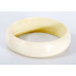 AN IVORY BANGLE NOT SUITABLE FOR EXPORT of plain form, inner diameter 65mm