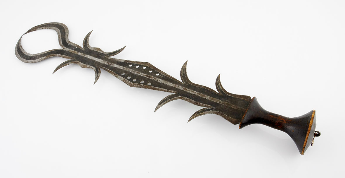 AN NGOMBE CEREMONIAL SWORD, DEMOCRATIC REPUBLIC OF CONGO a shaped steel blade with wooden hilt