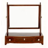 A GEORGE III FLAME MAHOGANY GENTLEMAN'S MIRROR the oval moulded plate within a conforming frame