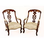 A PAIR OF ROSEWOOD ARMCHAIRS, EARLY 20TH CENTURY each arched top rail above a pierced and carved