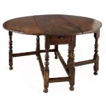 AN OAK GATE-LEG TABLE, 18TH CENTURY the oval top with hinged drop sides above a plain frieze, on