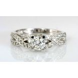 A DIAMOND RING centred with a brilliant-cut diamond weighing 0.443cts, the gallery and stylised