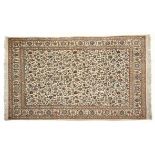 A FINE SILK RUG, PERSIA, MODERN the ivory field with an overall design of poly-chrome scrolling