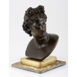 A CONTINENTAL PATINATED BRONZE BUST OF APOLLO his head turned to the right, with contemplative