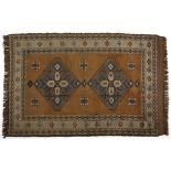 A TURKISH RUG, MODERN the plain red field with a stylised floral medallion depicted in gold and