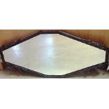 AN ART DECO WALL MIRROR the diamond-shaped plate within a cast-iron frame, surmounted by foliate