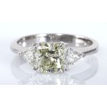 A DIAMOND RING centred with a claw-set tinted princess-cut diamond weighing approximately 1.40cts,