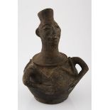 A CHOKWE CLAY VESSEL, ANGOLA the spout modelled in the form of a head, the ovoid body with molded