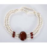 A THREE-STRAND PEARL CHOKER composed of three strands of cultured pearls, approximately 8,4mm to 9,