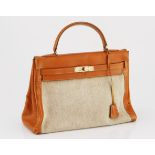 A VINTAGE HERMES KELLY HANDBAG caramel box calf leather with beige canvas inset and gold metal