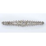 A DIAMOND BROOCH designed as a graduated bar brooch, millegrain set with graduated old- and point-