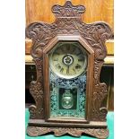 AN AMERICAN ANSONIA OAK MANTEL CLOCK WITH ALARM the 15cm brass dial with Roman numeral hour markers,