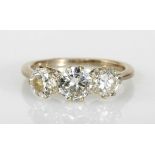 A THREE-STONE DIAMOND RING centred with a brilliant-cut diamond weighing approximately 0.67cts,