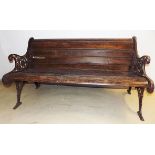 A VICTORIAN WOOD AND CAST-IRON BENCH the slatted back and seat between pierced and scrolling