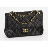 A VINTAGE CHANEL 2.55 CLASSIC FLAP black quilted leather with gold metal hardware, adjustable