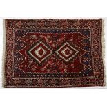 AN AFSHAR RUG, PERSIA, MODERN the red field with two stepped diamond medallions depicted in ivory,