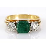 AN EMERALD AND DIAMOND RING centred with a square emerald-cut emerald weighing approximately 1.