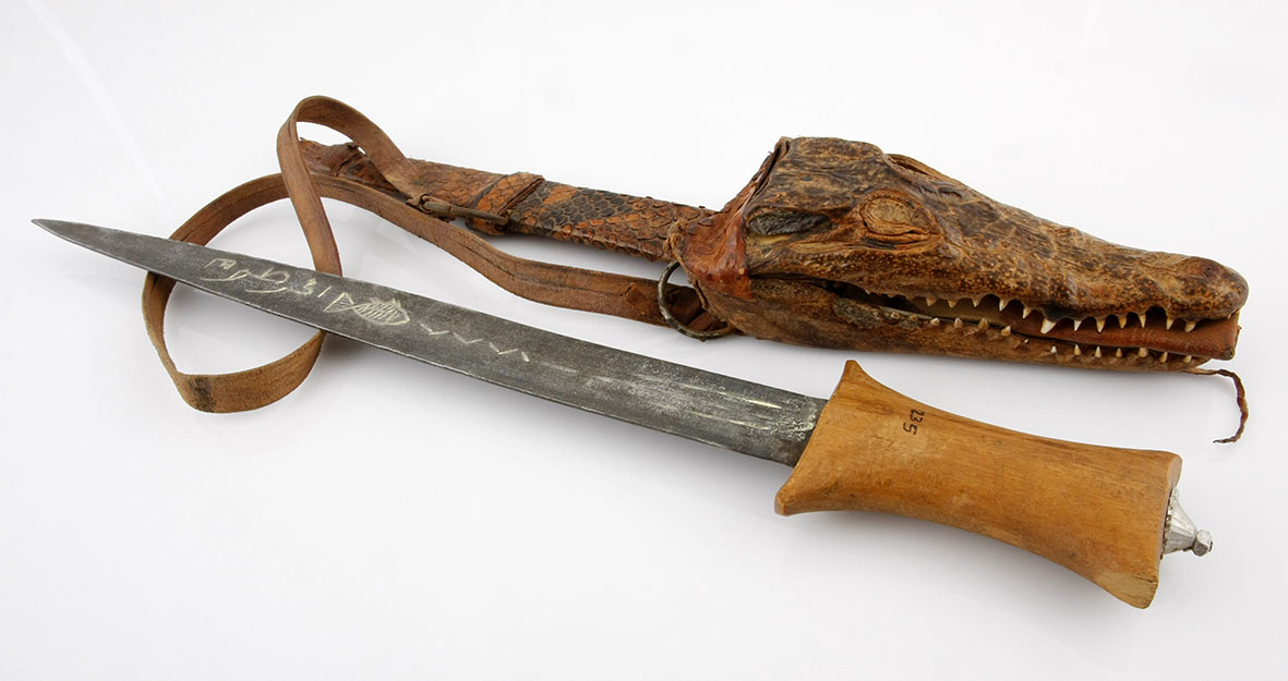 A NUBIAN DAGGER, NORTHERN SAHARA NOT SUITABLE FOR EXPORT the forged steel blade with wooden hilt,