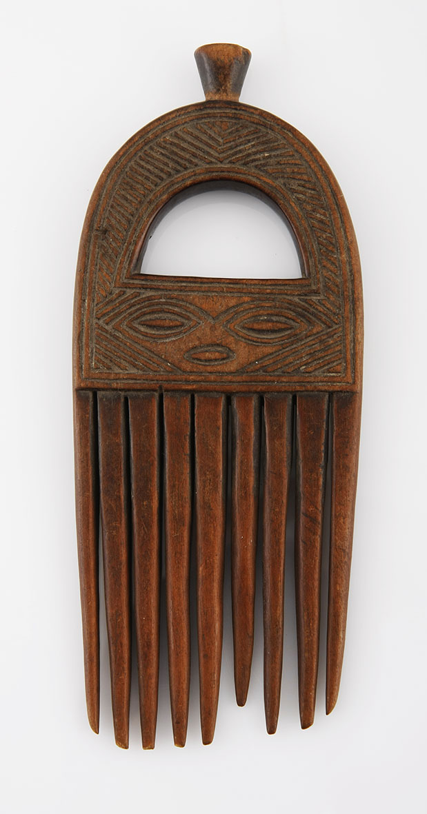 A CHOKWE COMB, ANGOLA the handle pierced and carved with geometric patterns 18cm long