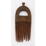 A CHOKWE COMB, ANGOLA the handle pierced and carved with geometric patterns 18cm long