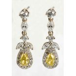 A PAIR OF DIAMOND PENDANT EARRINGS each designed as an articulated line of brilliant- and marquise-