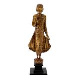 A THAI PAINTED AND CARVED FIGURE OF A STANDING BUDDHA, 20TH CENTURY modelled with serene expression,