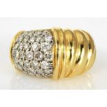 AN 18CT GOLD AND DIAMOND RING the broad band of cable design, pave-set to the side with brilliant-