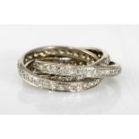 A DIAMOND RING composed of three bands, each pavé-set with brilliant-cut diamonds weighing