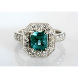 AN EMERALD AND DIAMOND RING centered with a square emerald-cut emerald weighing approximately 1.