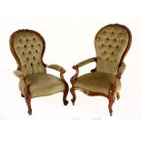 A VICTORIAN MAHOGANY AND UPHOLSTERED ARMCHAIR the padded button back within a conforming frame