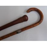 Walking cane with silver band and a carved walking stick