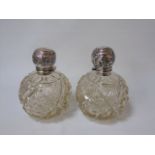 A near pair of silver topped scent bottles date marked Birmingham 1910 and 1911