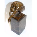 Bronze figure of a man in a diving pose on marble plinth